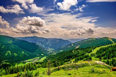 Scenic view of mountains against cloudy sky