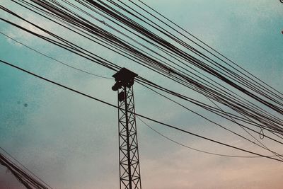 Low angle view of electricity pylon against sky