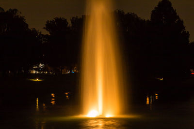 Illuminated fountain at night