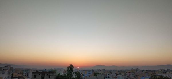 High angle view of townscape against clear sky at sunset