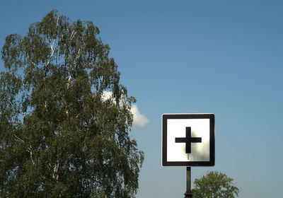 Low angle view of road sign against clear sky