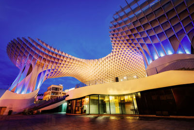 Low angle view of modern building against blue sky