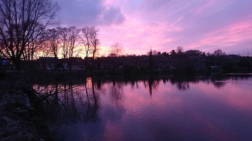 Scenic view of river against sky at sunset