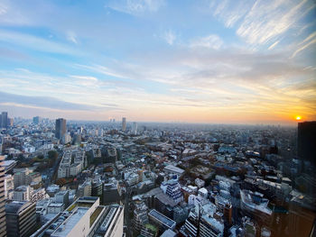 High angle view of city buildings against sky during sunset