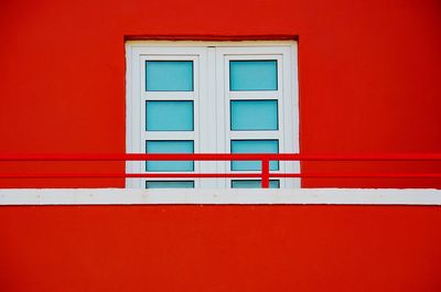 Close-up of window on red wall