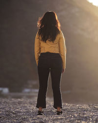 Rear view of woman standing on land