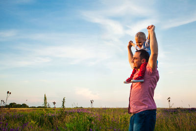 Happy father with son on field