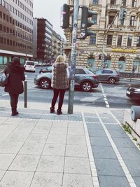 Rear view of people on city street