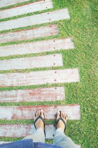 Low section of man standing on footpath