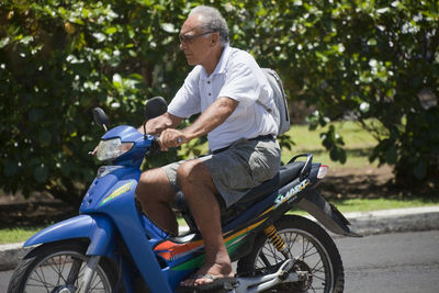 Side view of a man riding motorcycle