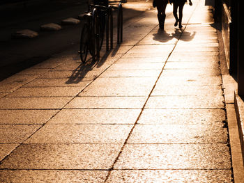 Low section of people walking on sidewalk