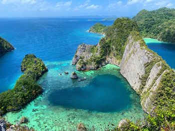 High angle view of rocks in sea of the love heart shape lagoon in misool raja ampat 