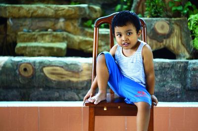 Portrait of cute girl sitting on steps