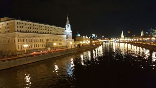 Illuminated buildings with waterfront at night