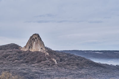 Rock formations on landscape against sky