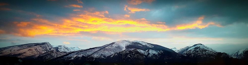 Low angle view of snowcapped mountains against sky during sunset