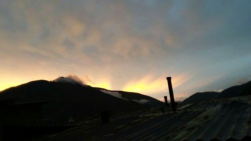 Scenic view of mountains against sky at sunset