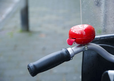 Close-up of red bell on bicycle handle