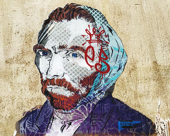 Portrait of man with graffiti on wall