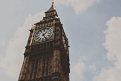 Low angle view of tower against cloudy sky