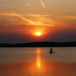 Scenic view of sea against orange sky