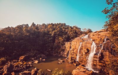 Panoramic view of rocks and trees against sky