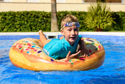 Portrait of smiling boy in swimming pool