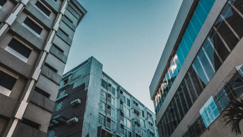 Low angle view of modern buildings against clear blue sky