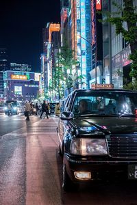 Cars on city street at night