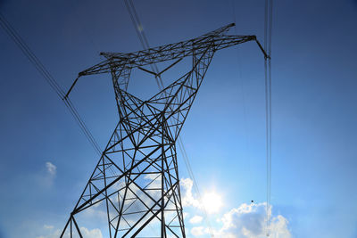 Low angle view of electricity pylon against sky