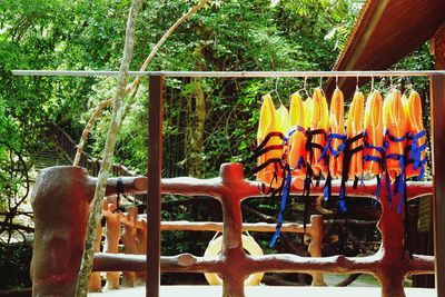 View of multi colored metal fence against trees