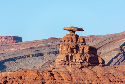 View of rock formation against clear blue sky