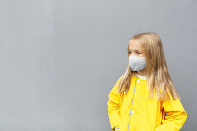 Kid raincoat and face mask during coronavirus colors of the year 2021 ultimate gray and illuminating
