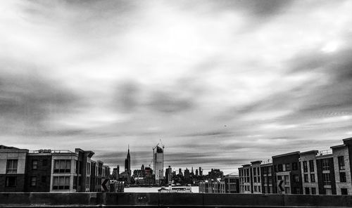 Buildings against cloudy sky