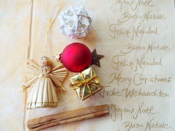 Close-up of christmas decoration with letter on table