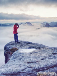 Woman watching sunrise over himalayas, misty mountains national park