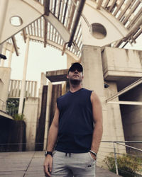 Portrait of young man wearing sunglasses while standing in city