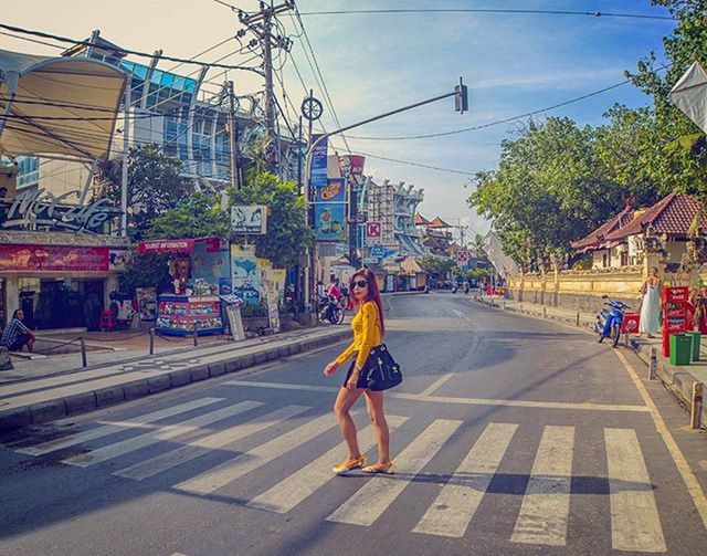 building exterior, full length, architecture, built structure, street, city, lifestyles, transportation, road, walking, rear view, casual clothing, men, city life, the way forward, leisure activity, sky, day