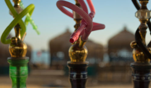 Close-up of hubbly bubbly against sky