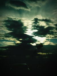 Train on road against cloudy sky