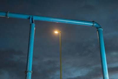 Low angle view of railing against sky