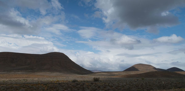 Scenic view of arid landscape against sky