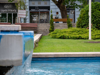 Fountain in swimming pool by canal