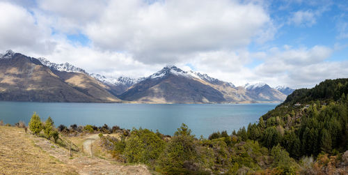 Scenic view of mountains against cloudy sky