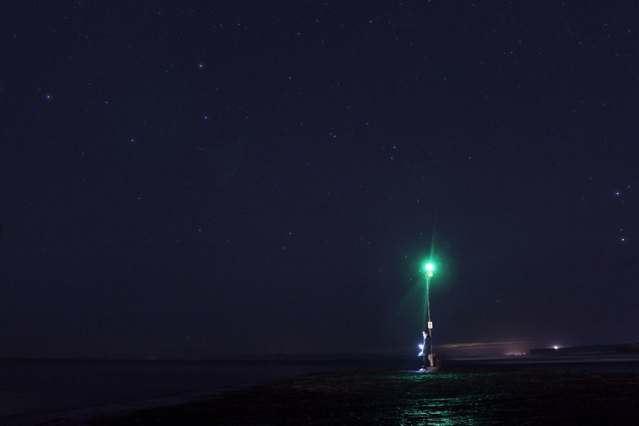 night, water, sea, illuminated, tranquil scene, scenics, tranquility, beauty in nature, copy space, nature, clear sky, dark, waterfront, reflection, idyllic, sky, horizon over water, outdoors, blue, moon