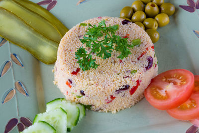 Close-up of couscous and salad served on plate