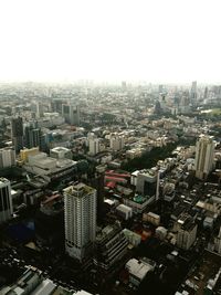 High angle view of buildings in city against clear sky