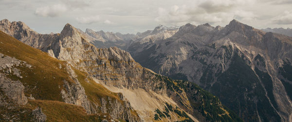 Panoramic view of land and mountains against sky