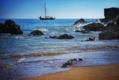 Scenic view of sea against clear blue sky