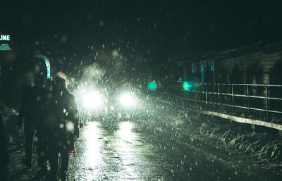 Cars on wet street during rainy season at night